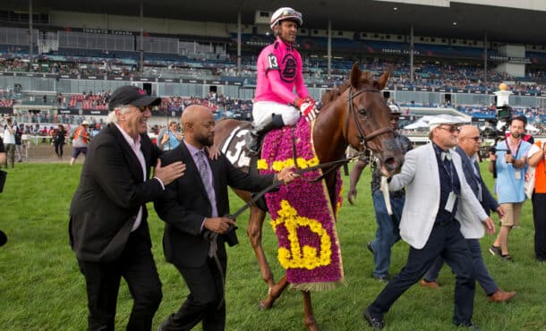 People walking a horse into the winner's circle