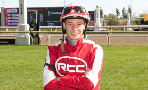 A jockey in red-and-white silks.