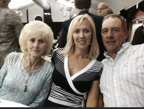Two women and a man at a table.