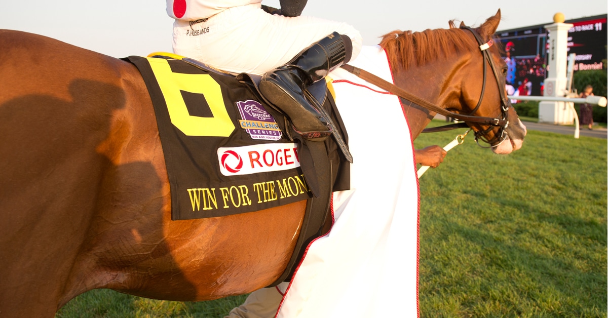 A chestnut horse heading to the winners circle.
