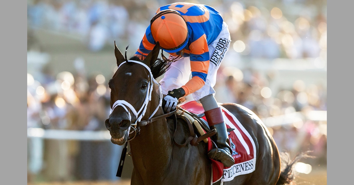 A dark bay horse winning a race in Del Mar.