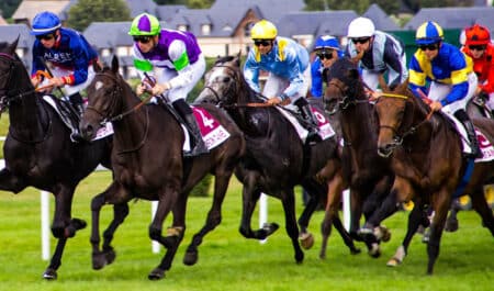 Horses racing on the turf.