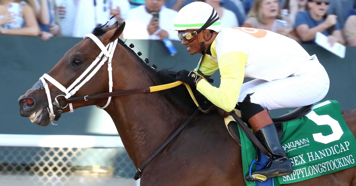 A man riding a bay racehorse at Oaklawn.