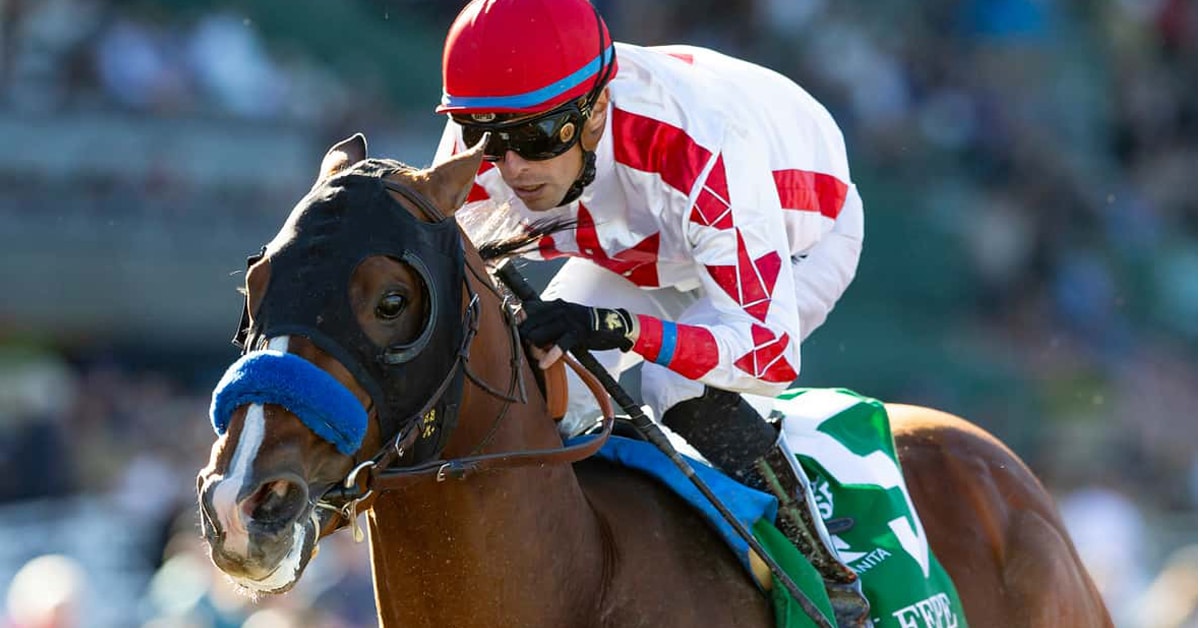 A bay horse winning a race at Santa Anita.