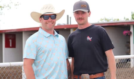 Two smiling men at an Alberta racetrack.