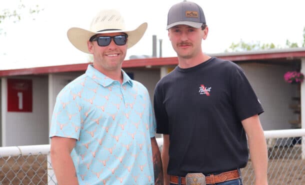 Two smiling men at an Alberta racetrack.