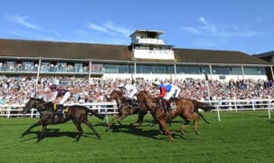 Horses racing on the turf in England.
