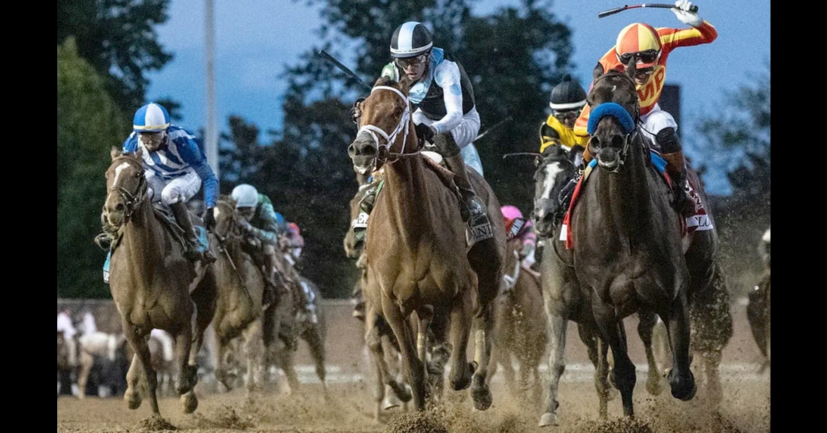 Head-on shot of horses racing at Churchill Downs.