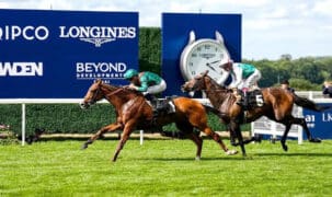 Horses racing on the turf at Ascot.