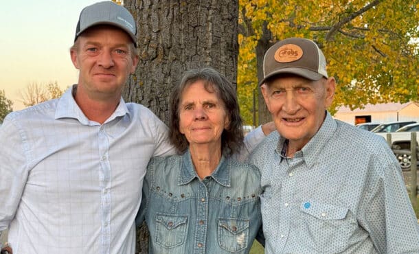Two men and a woman at the racetrack.